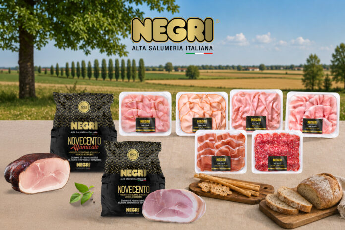 Assorted NEGRI Italian deli meats in plastic trays and black packaging on a wooden table, countryside backdrop with green fields and blue sky.