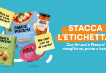 Colorful Italian ad for Amarsi è Piacersi; boxed pasta, jar sauce and snacks on a teal background with bold orange banner text STACCA L'ETICHETTA!