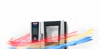 RATIONAL premiata ai Barawards con iHexagon e Digital Service Management RATIONAL iHexagon commercial oven with a touch-screen panel and stainless steel body, set against a hexagon-pattern background.
