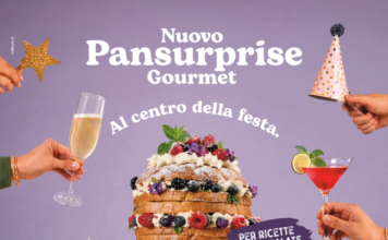 Pansurprise diventa Gourmet: Valle Fiorita alza il livello della gastronomia Promotional image for Nuovo Pansurprise Gourmet featuring a tall layered cake with berries and cream, flanked by champagne glasses and party hats for a festive center-plate celebration theme.