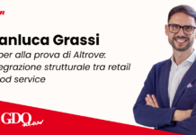 Promotional banner featuring Gianluca Grassi from Finiper with Italian headline about retail and food-service integration; logos on left and red diagonal banner at bottom left.