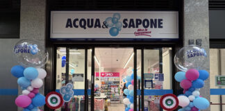 Cesar porta Acqua & Sapone a quota 150 punti vendita in Lombardia Storefront of Acqua e Sapone during a grand opening with pink carpet, blue and pink balloon columns, and a ribbon in front of glass doors.
