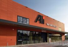 Alì chiude il 2025 con 46 milioni di utile e rilancia sugli investimenti Orange modern building with large