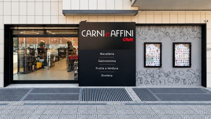Carni e Affini - Crai Storefront of Carni e Affini butcher and deli with a black sign listing Macelleria, Gastronomia, Frutta e Verdura, Enoteca.