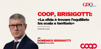 Domenico Brisigotti in a suit on the left with a beige background; bold red headline about Coop Brisigotti and balancing scale and territory, plus author credit and logos (GDO News top right, Coop bottom right).