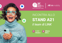 LINK Mobility al Salone Franchising Milano 2026: nuove strategie per connettere brand, punti vendita e clienti Promotional banner showing a smiling woman with teal glasses and sweater, inviting visitors to Stand A21 by LINK at Salone Franchising Milano.