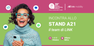 LINK Mobility al Salone Franchising Milano 2026: nuove strategie per connettere brand, punti vendita e clienti Promotional banner showing a smiling woman with teal glasses and sweater, inviting visitors to Stand A21 by LINK at Salone Franchising Milano.