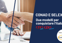 Selex e Conad: due modelli per conquistare l’Italia Handshake between two people on a business banner about CONAD and SELEX sponsorships.