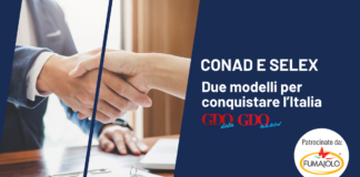 Selex e Conad: due modelli per conquistare l’Italia Handshake between two people on a business banner about CONAD and SELEX sponsorships.