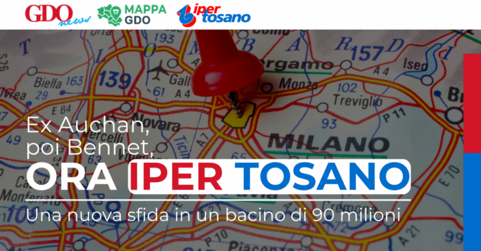 Map of Milan area with a red pushpin marking a location, overlaid with headline 'ORA IPER TOSANO' and logos at the top edge.