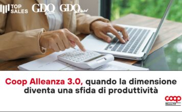 Person typing on a laptop while using a calculator on a desk; logos 'Top Sales', 'GDO data', 'GDO news' appear in the top-left.